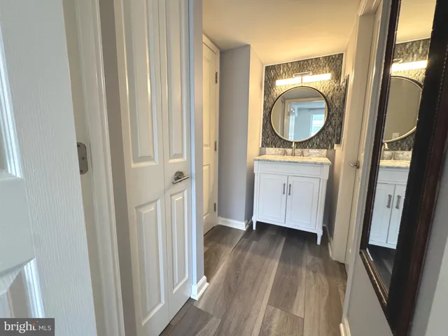 a view of a room with wooden floor