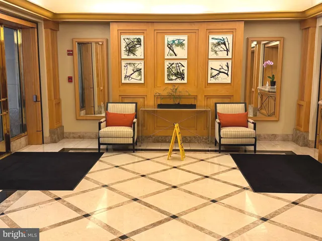 a living room with furniture and large windows