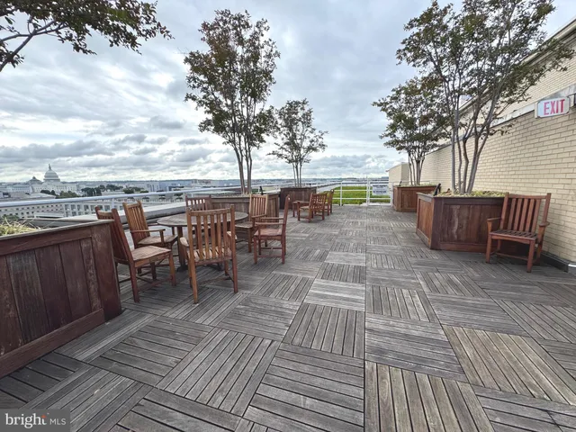 a living room with furniture and floor to ceiling windows