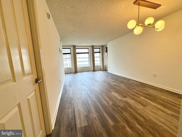 a view of a room with wooden floor and windows