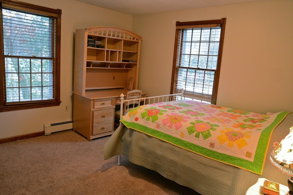 71 Emerson Road Walpole, MA 02032 - Photo 21 of 30 a bed sitting in a bedroom next to a window