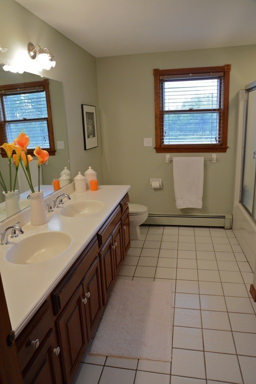 71 Emerson Road Walpole, MA 02032 - Photo 23 of 30 a bathroom with a sink and a mirror