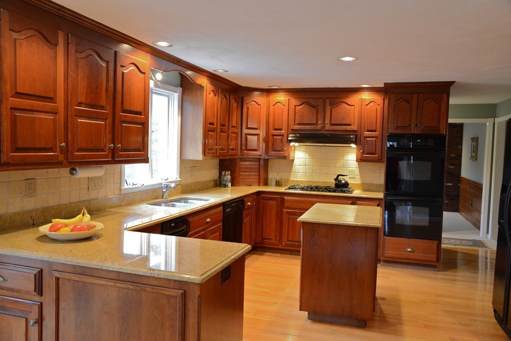 71 Emerson Road Walpole, MA 02032 - Photo 4 of 30 a kitchen with wooden cabinets and a sink