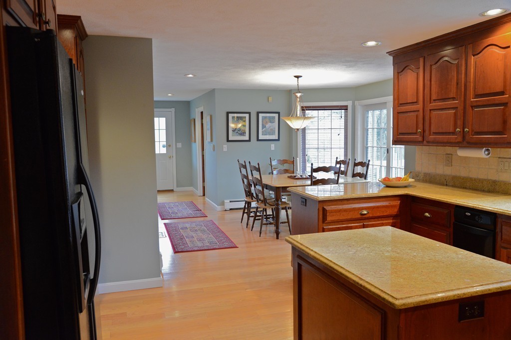 71 Emerson Road Walpole, MA 02032 - Photo 6 of 30 a kitchen with stainless steel appliances granite countertop a refrigerator a sink a stove and island