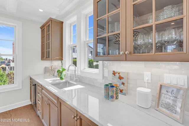 a bathroom with a sink a toilet and a window
