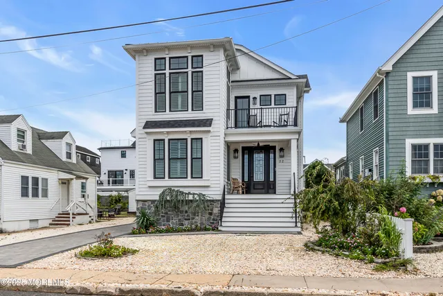 a front view of a house with yard and windows