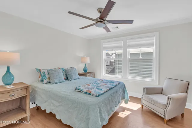 a bedroom with a bed a couch and a window