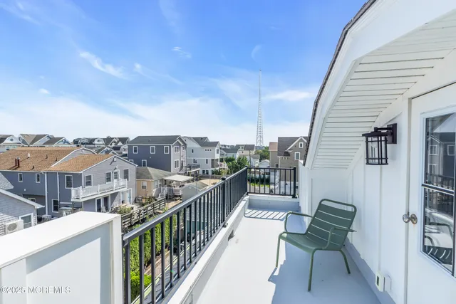 a view of a balcony with wooden chairs