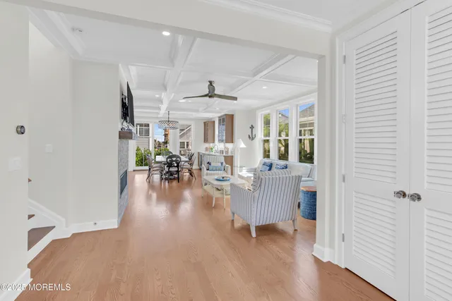 a view of a livingroom with furniture floor to ceiling window and wooden floor