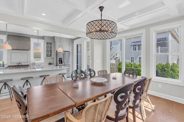 a view of a dining room with furniture wooden floor and chandelier