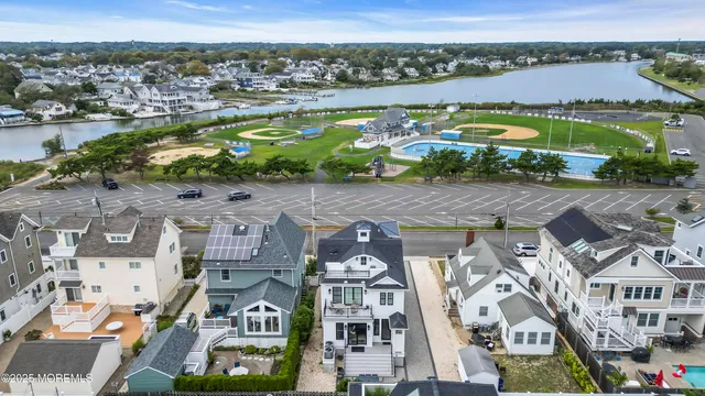 an aerial view of residential building with swimming pool and ocean view