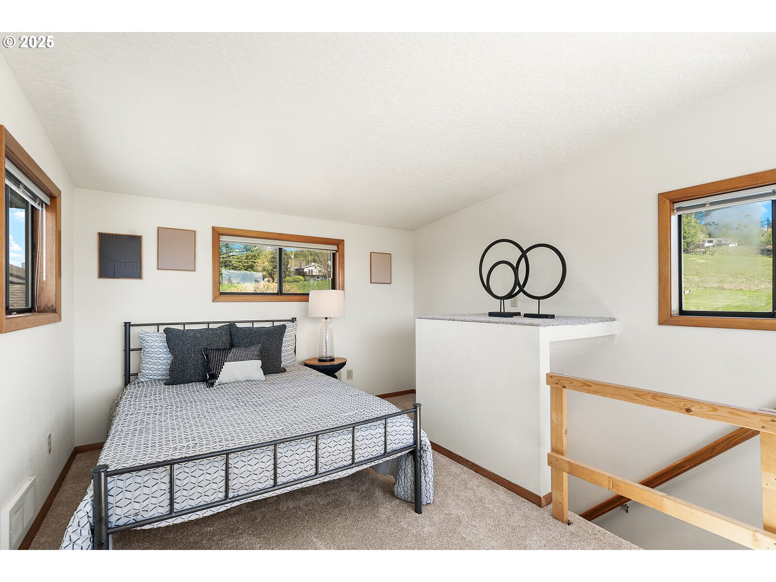 17233 Southeast McKinley Road Gresham, OR 97080 - Photo 35 of 48 a bedroom with a bed and paintings on the wall