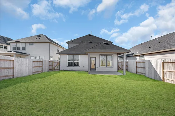 a view of a house with a big yard and large trees