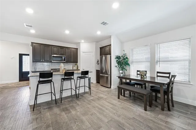 a view of kitchen with cabinets table and chairs