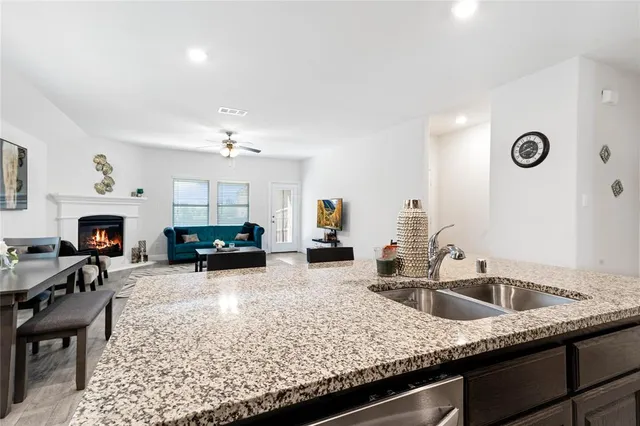 a kitchen with sink cabinets and dining table