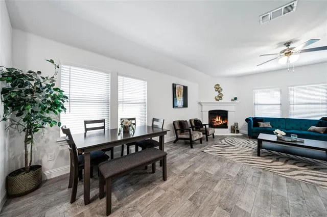 a living room with furniture a window and a fireplace