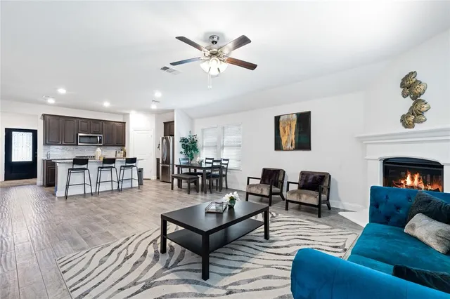 a living room with furniture and kitchen view