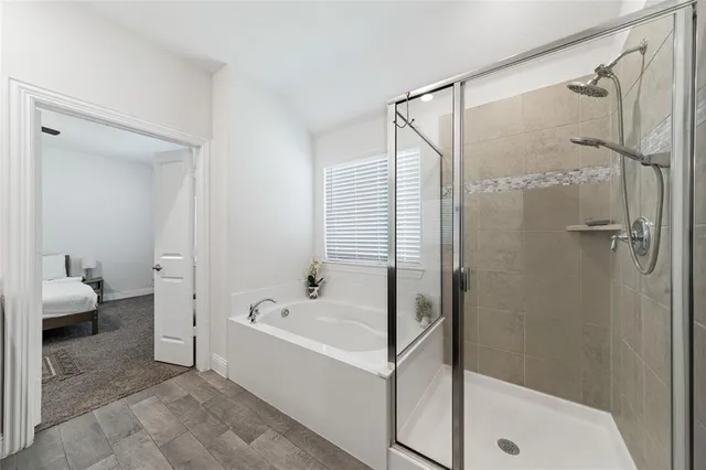 a bathroom with a bathtub and a shower