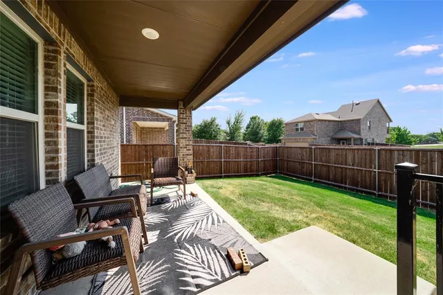 a view of a deck with chair and garden view