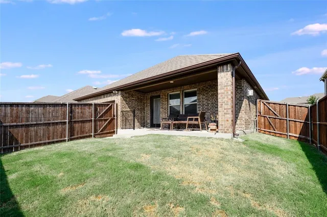 a view of a house with a yard and sitting area