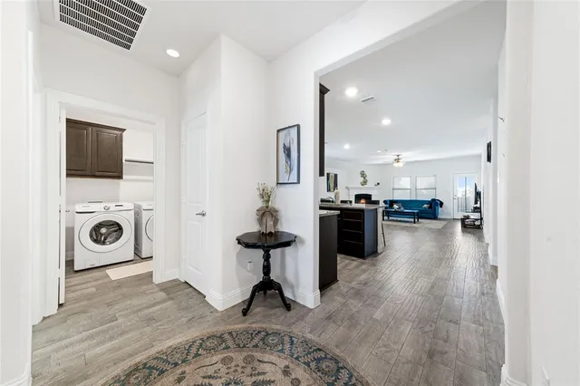 a kitchen with stainless steel appliances kitchen island granite countertop a stove top oven a sink a dining table and chairs