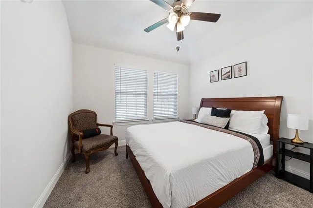 a bedroom with bed and chair