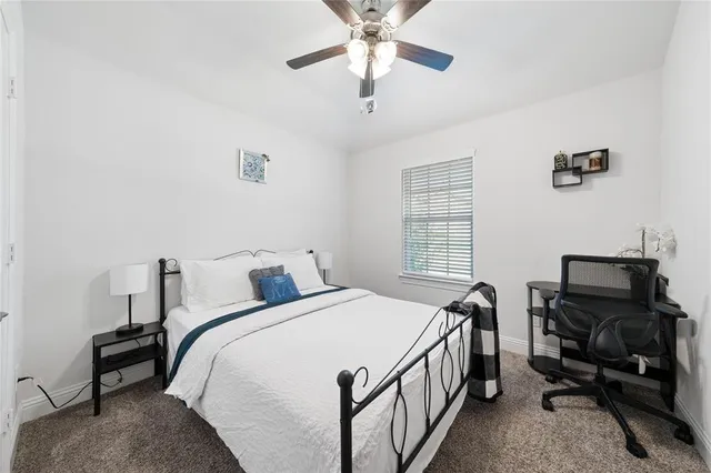 a bedroom with a bed a dresser and chair