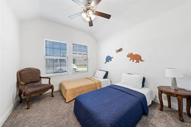 a bedroom with two beds and painting on the wall