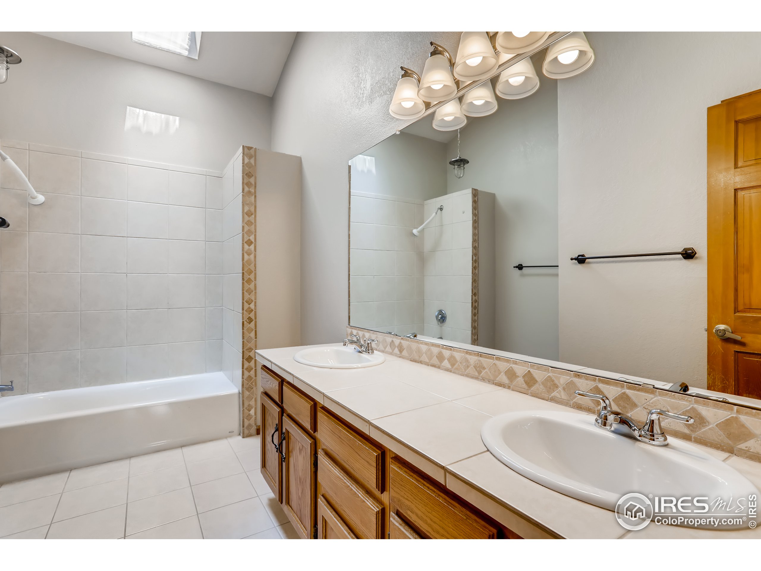 2315 Ranch Drive Westminster, CO 80234 - Photo 12 of 28 a bathroom with a sink a tub and a mirror