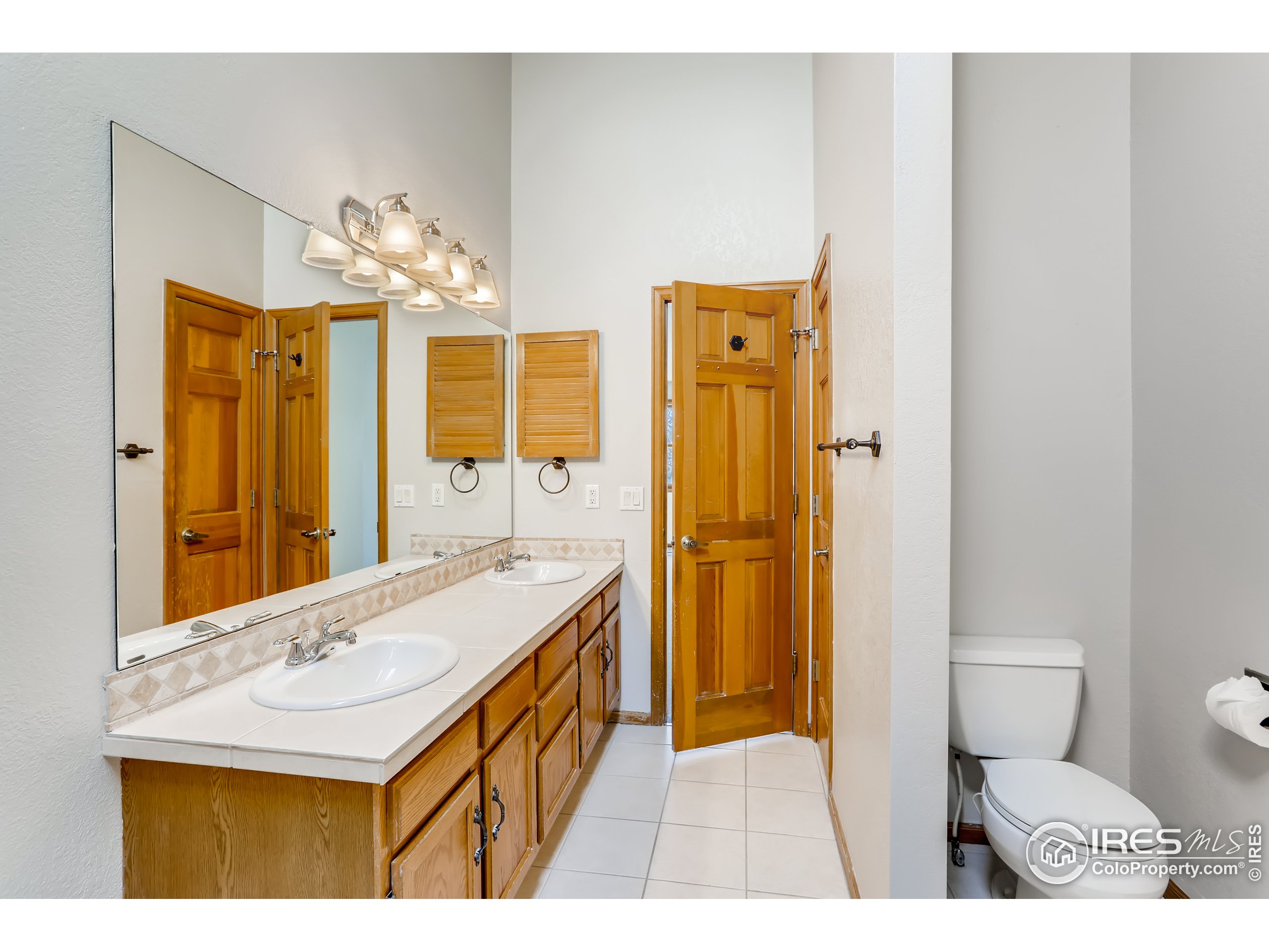 2315 Ranch Drive Westminster, CO 80234 - Photo 13 of 28 a bathroom with a sink a toilet and shower