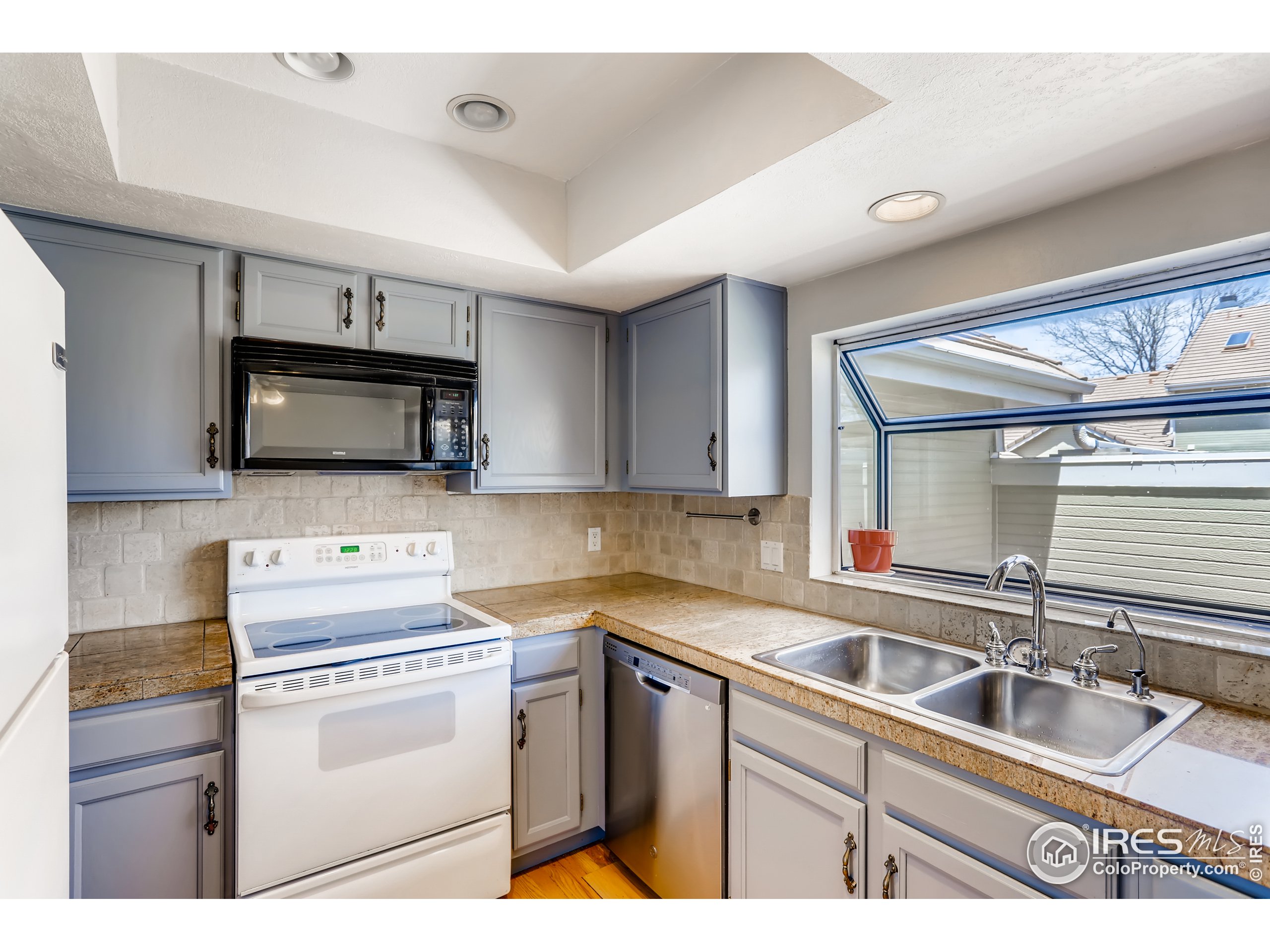 2315 Ranch Drive Westminster, CO 80234 - Photo 5 of 28 a kitchen with appliances a sink and a window