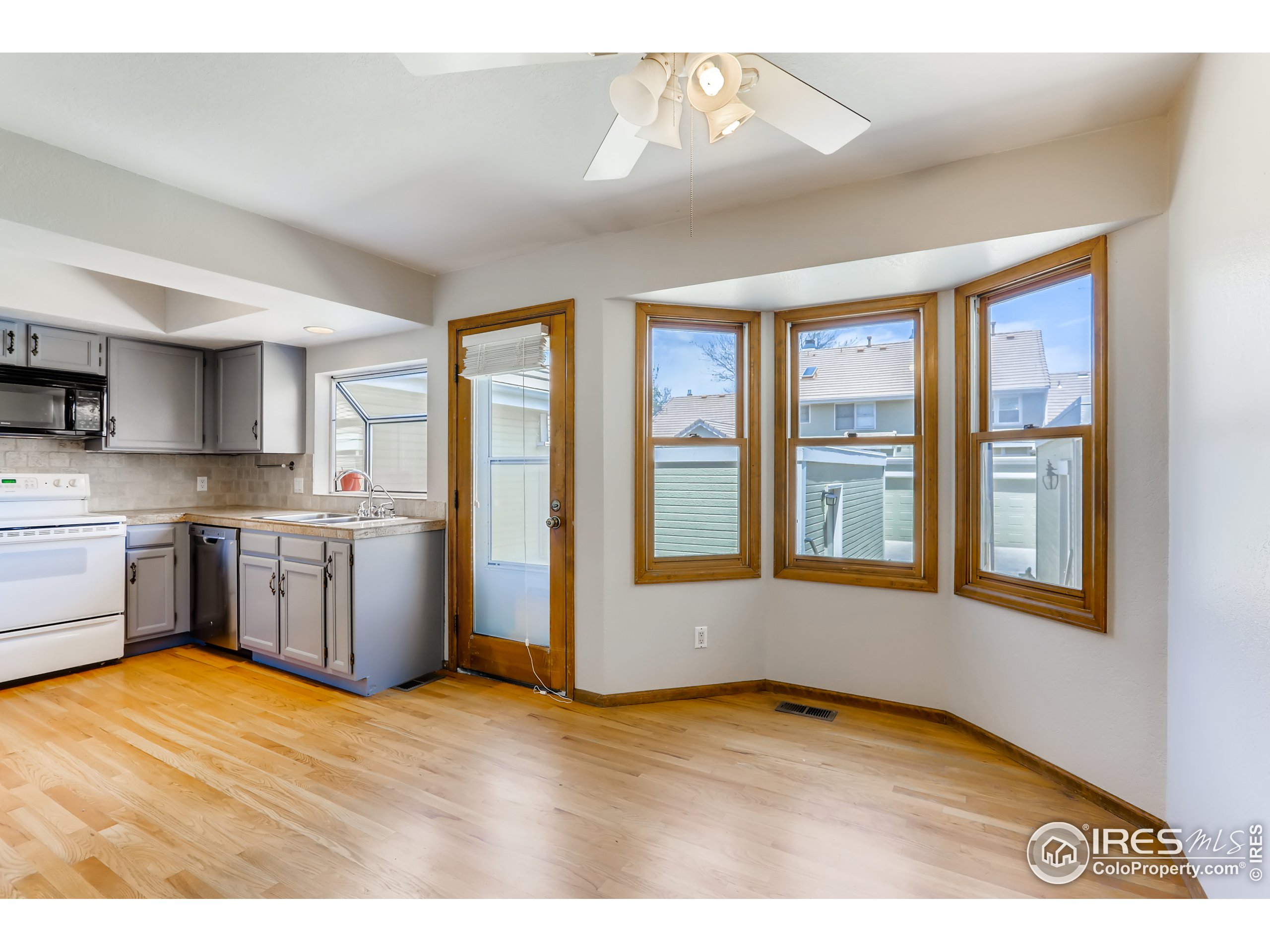 2315 Ranch Drive Westminster, CO 80234 - Photo 7 of 28 a kitchen with a stove a sink and a refrigerator