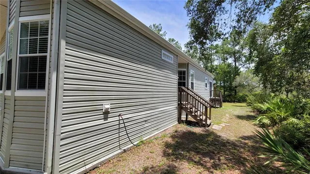 a view of backyard of house with outdoor seating