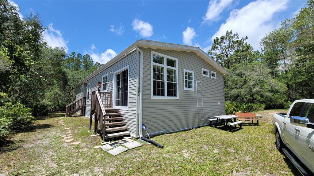 3690 Southeast 54th Avenue Morriston, FL 32668 - Photo 2 of 43 a backyard of a house with barbeque oven