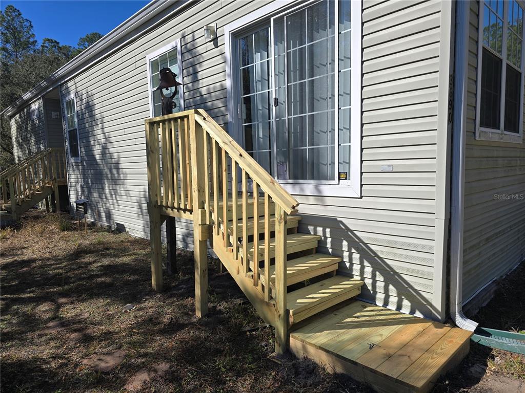 3690 Southeast 54th Avenue Morriston, FL 32668 - Photo 22 of 43 a view of wooden balcony with two chairs and a wooden fence