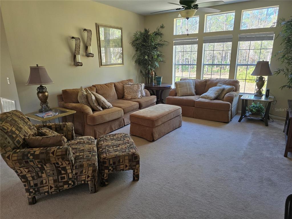 3690 Southeast 54th Avenue Morriston, FL 32668 - Photo 34 of 43 a living room with furniture and a large window