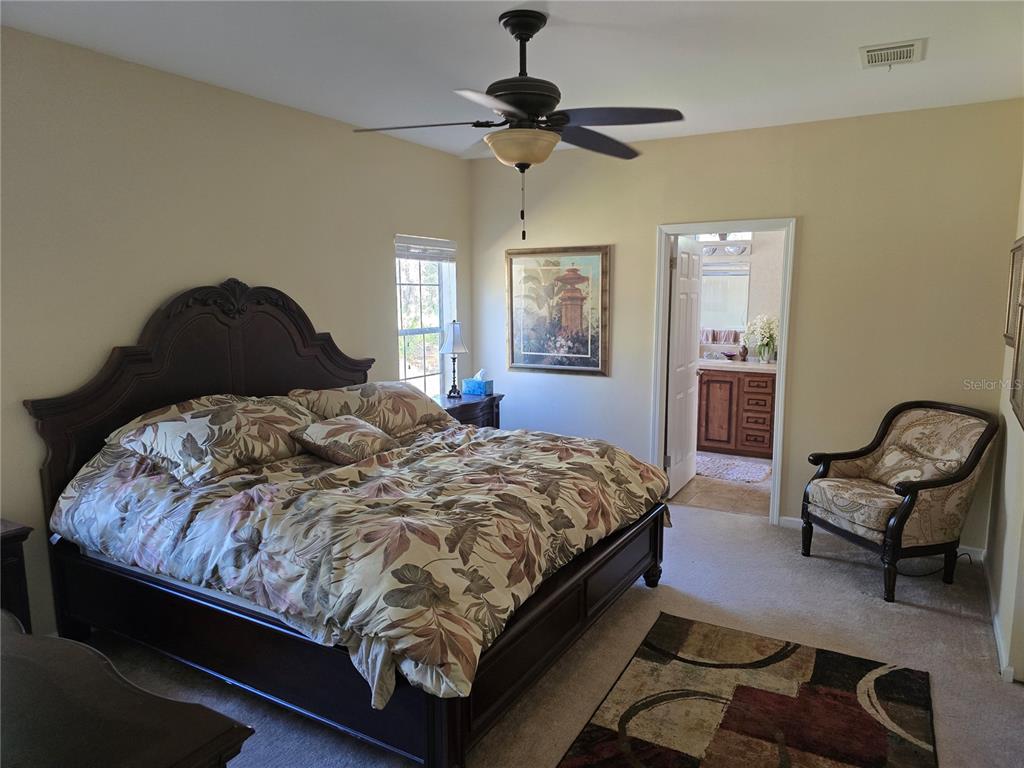 3690 Southeast 54th Avenue Morriston, FL 32668 - Photo 37 of 43 a bedroom with a bed and window