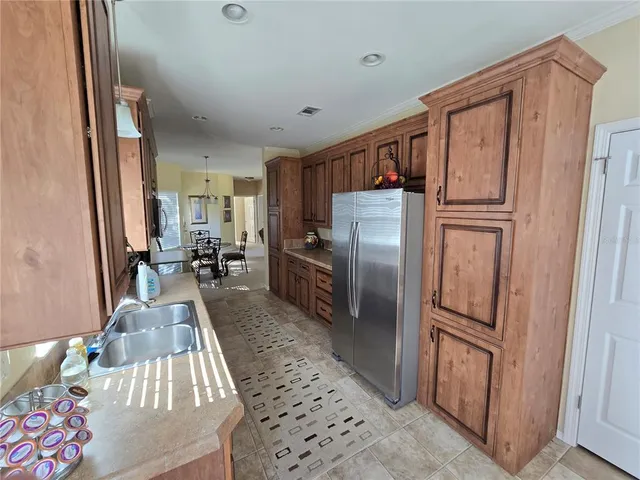 a kitchen with stainless steel appliances granite countertop a refrigerator and a stove