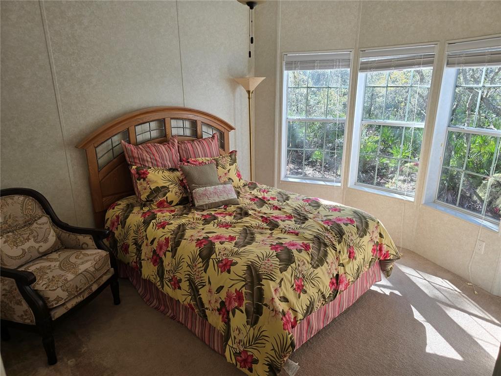 3690 Southeast 54th Avenue Morriston, FL 32668 - Photo 43 of 43 a bed sitting in a bedroom next to a window