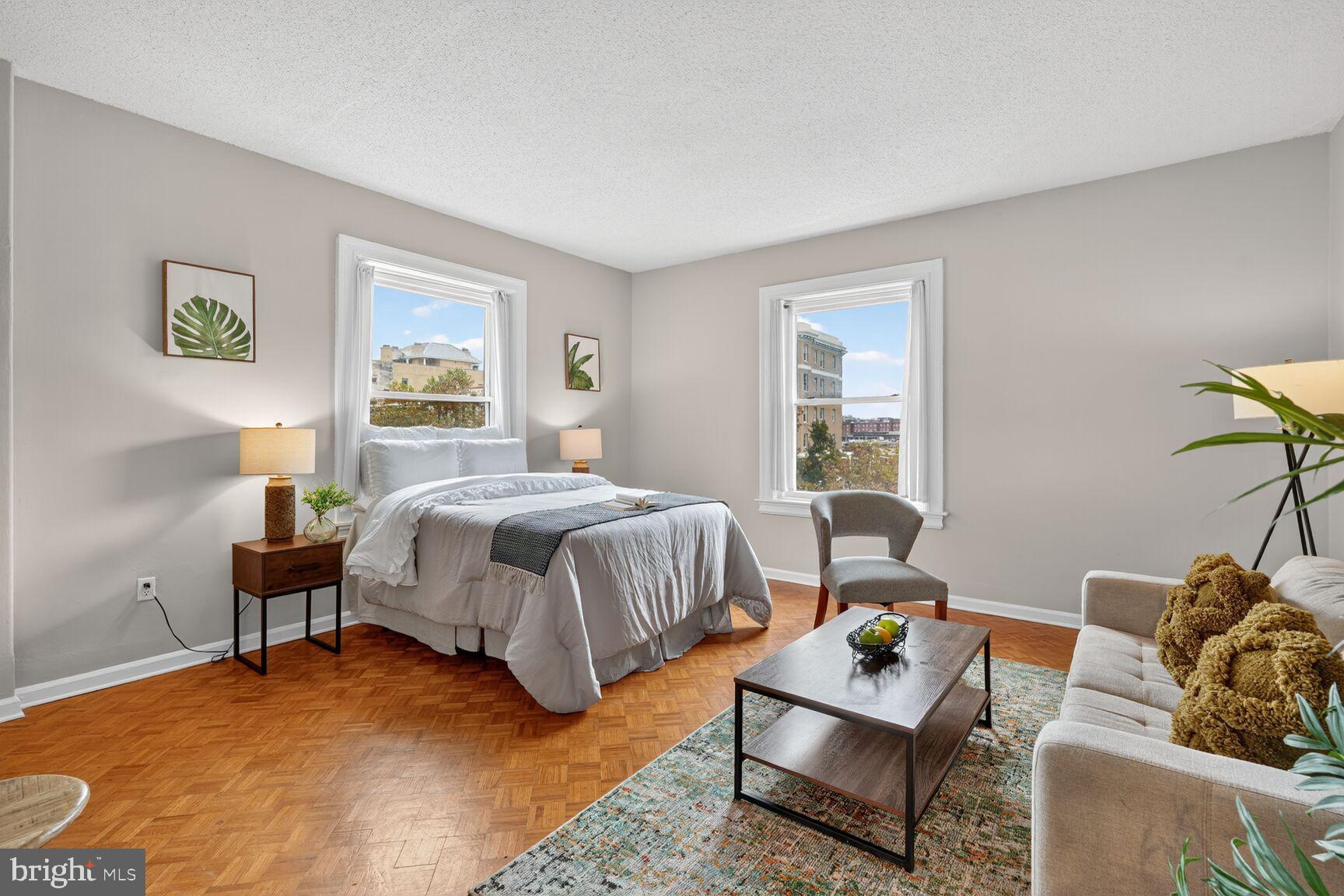 1851 Columbia Road Northwest, Unit 303 Washington, DC 20009 - Photo 2 of 10 a bedroom with a bed and wooden floor