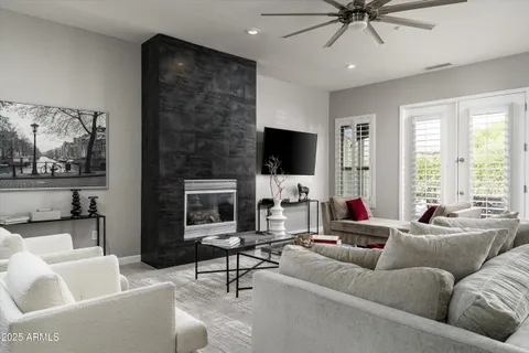a living room with fireplace furniture and a flat screen tv