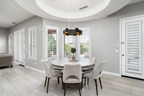 a view of a dining room with furniture and a large window