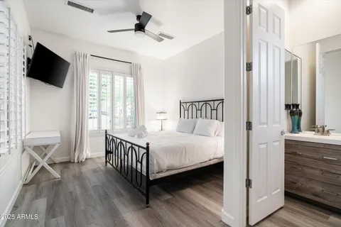 a bathroom with a granite countertop sink toilet and mirror