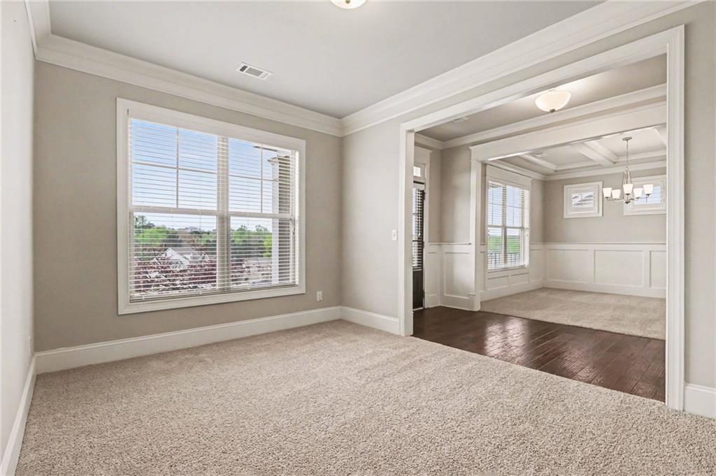 2960 Hampton Grv Trace Dacula, GA 30019 - Photo 11 of 33 a view of an empty room with wooden floor and a window