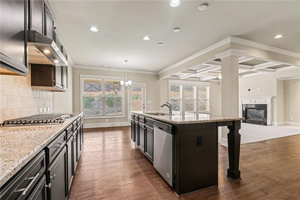 2960 Hampton Grv Trace Dacula, GA 30019 - Photo 13 of 33 a kitchen with stainless steel appliances granite countertop sink stove top oven and cabinets