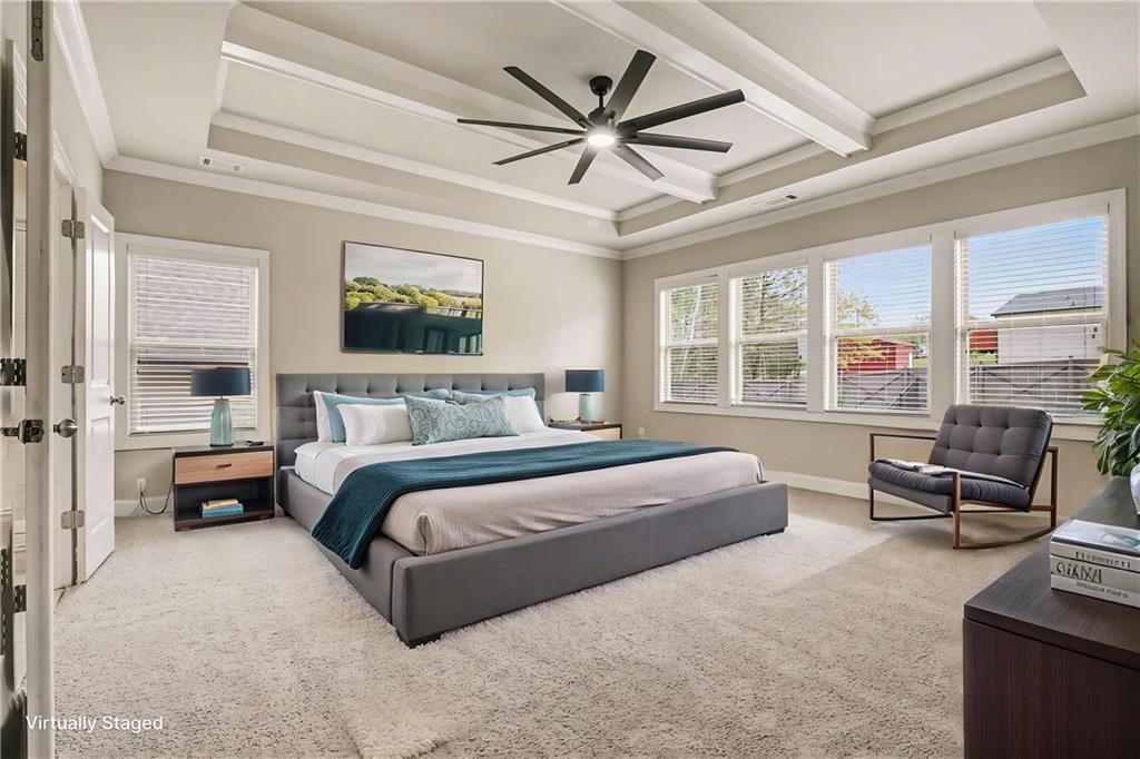 2960 Hampton Grv Trace Dacula, GA 30019 - Photo 15 of 33 a spacious bedroom with a bed a couch and a large window