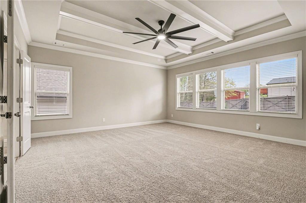 2960 Hampton Grv Trace Dacula, GA 30019 - Photo 16 of 33 an empty room with windows and ceiling fan