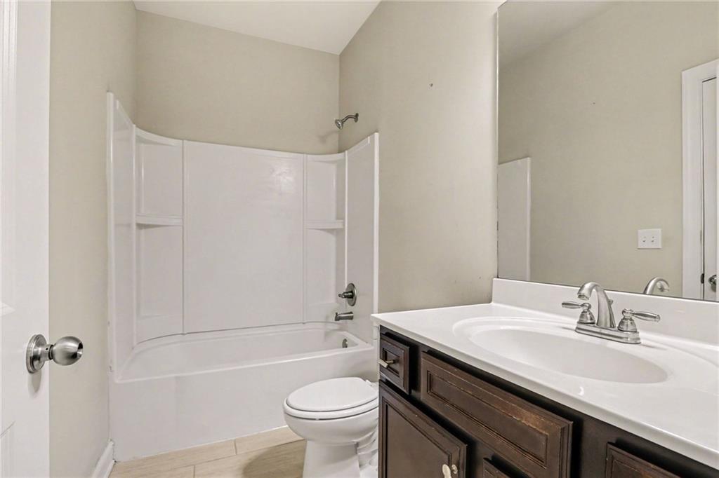 2960 Hampton Grv Trace Dacula, GA 30019 - Photo 19 of 33 a bathroom with a granite countertop sink toilet and shower