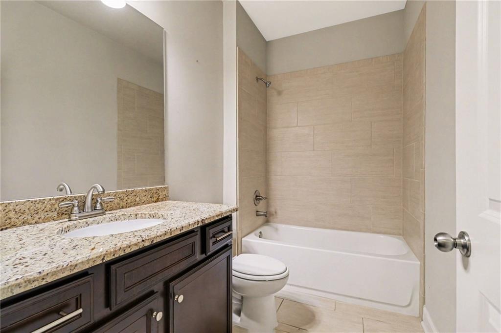 2960 Hampton Grv Trace Dacula, GA 30019 - Photo 22 of 33 a bathroom with a granite countertop sink toilet and shower