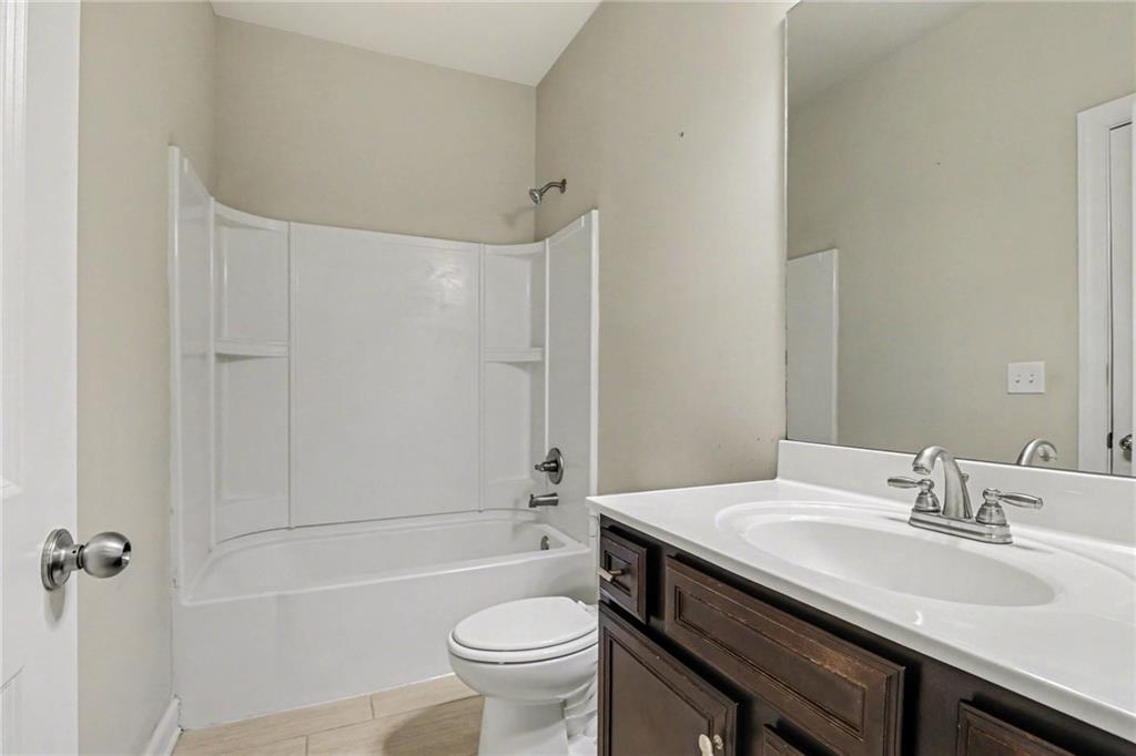 2960 Hampton Grv Trace Dacula, GA 30019 - Photo 23 of 33 a bathroom with a sink a toilet and shower